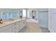 This bathroom has a large tub and a glass shower with gray marble counters at 19293 Breynia Dr, Lutz, FL 33558
