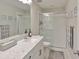 This bathroom features a large mirror, and glass shower with gray marble counters at 19293 Breynia Dr, Lutz, FL 33558