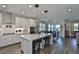 Bright, open-concept kitchen with a large island, modern appliances, and adjacent dining area with lake views at 19293 Breynia Dr, Lutz, FL 33558