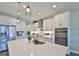 Gourmet kitchen featuring white cabinetry, stainless steel appliances, and a spacious island with counter seating at 19293 Breynia Dr, Lutz, FL 33558