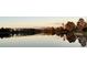 Still lake at sunset reflects a tranquil view of the surrounding trees and fading light at 19293 Breynia Dr, Lutz, FL 33558
