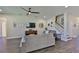Cozy living room featuring a neutral-toned sofa, large TV, and staircase access to the upper level at 19293 Breynia Dr, Lutz, FL 33558