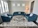 Inviting living room with stylish blue seating and a modern coffee table, perfect for relaxation and entertaining at 19293 Breynia Dr, Lutz, FL 33558