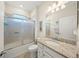 Bathroom with shower and bathtub, granite countertop vanity, and updated fixtures at 19369 Nearpoint Dr, Venice, FL 34292
