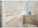 Bright bathroom featuring a walk in shower, a tub and large windows at 19369 Nearpoint Dr, Venice, FL 34292