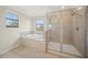 Bright bathroom featuring a separate tub and enclosed shower at 19369 Nearpoint Dr, Venice, FL 34292