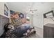 Comfortable bedroom features a fan, floral decor, and a large window at 19369 Nearpoint Dr, Venice, FL 34292