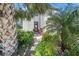 Inviting front entrance with a decorated door, enhanced by lush landscaping and a brick walkway at 19369 Nearpoint Dr, Venice, FL 34292