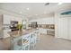 Spacious kitchen features white cabinets, stainless appliances, granite countertops, and a large central island at 19369 Nearpoint Dr, Venice, FL 34292
