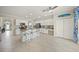 Spacious kitchen features white cabinets, stainless appliances, granite countertops, and a large central island at 19369 Nearpoint Dr, Venice, FL 34292