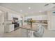 Spacious kitchen features white cabinets, stainless appliances, granite countertops, and a large central island at 19369 Nearpoint Dr, Venice, FL 34292