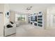 Comfortable living room featuring tile floors, a large entertainment center, and a window with natural light at 19369 Nearpoint Dr, Venice, FL 34292