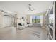 Spacious living room with a neutral color palette, tile floors, a ceiling fan, and a large window with blinds at 19369 Nearpoint Dr, Venice, FL 34292
