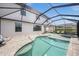Backyard pool area with a spa, screened-in enclosure, and comfortable patio seating at 19369 Nearpoint Dr, Venice, FL 34292