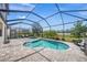 Relaxing screened-in pool area with lush greenery and a hot tub, perfect for outdoor entertaining at 19369 Nearpoint Dr, Venice, FL 34292
