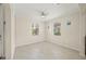 Bright and airy room featuring neutral paint, tile flooring, and natural light from two windows at 19369 Nearpoint Dr, Venice, FL 34292