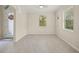 Bright and airy room featuring neutral paint, tile flooring, and natural light from two windows at 19369 Nearpoint Dr, Venice, FL 34292