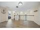 Upstairs landing with wood flooring, access to bedrooms, and a view of the lower level, bathed in natural light at 19369 Nearpoint Dr, Venice, FL 34292