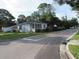 Inviting single-story home showcasing a quaint covered porch and lush greenery in a tranquil setting at 2102 Arlington St, Sarasota, FL 34239