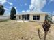 View of the backyard with a screened in patio and freshly planted flora in a sunny location at 2122 Pleasure Run Dr, Ruskin, FL 33570