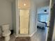 This bathroom features a white toilet, a large shower and wood-look floors at 2122 Pleasure Run Dr, Ruskin, FL 33570