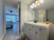 Bright bathroom featuring a gray vanity with a white countertop, a black faucet and a framed mirror at 2122 Pleasure Run Dr, Ruskin, FL 33570