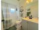 Bright bathroom with a shower-tub combo, white tile, and a vanity with green towels at 2122 Pleasure Run Dr, Ruskin, FL 33570