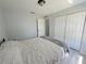 This bedroom has gray walls, wood-look floors, and a double-door closet at 2122 Pleasure Run Dr, Ruskin, FL 33570