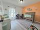Cozy Bedroom with a gray crib, changing table, and an accent wall with baby-themed décor at 2122 Pleasure Run Dr, Ruskin, FL 33570