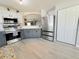 Bright kitchen boasts stainless steel appliances, white upper cabinets, and gray lower cabinets at 2122 Pleasure Run Dr, Ruskin, FL 33570
