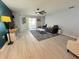 Spacious living room features hardwood flooring, a ceiling fan, and a sliding glass door at 2122 Pleasure Run Dr, Ruskin, FL 33570