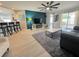 Open-concept living room with a view of the kitchen, hardwood flooring, and lots of light at 2122 Pleasure Run Dr, Ruskin, FL 33570