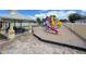 Community playground with colorful slides, climbing structures and adjacent shaded picnic area at 2122 Pleasure Run Dr, Ruskin, FL 33570