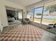 Relaxing sunroom with checkered rug and comfortable chair, offering a serene view of the backyard at 2122 Pleasure Run Dr, Ruskin, FL 33570
