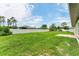Spacious backyard featuring a well-maintained lawn and white privacy fence, perfect for outdoor activities at 2237 Sadnet Ln, North Port, FL 34286
