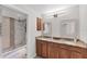 Bathroom featuring a double vanity with granite countertops and a tiled walk-in shower at 2237 Sadnet Ln, North Port, FL 34286