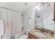 Bathroom featuring a granite-topped vanity, shower-tub combo, and neutral color scheme at 2237 Sadnet Ln, North Port, FL 34286