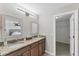 Bathroom featuring a double vanity with granite countertops and modern lighting fixtures at 2237 Sadnet Ln, North Port, FL 34286
