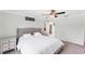 Comfortable bedroom featuring a ceiling fan, carpeted floors, and a view into the en-suite bathroom at 2237 Sadnet Ln, North Port, FL 34286