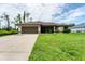 Inviting single-story home featuring a well-maintained lawn and a spacious two-car garage at 2237 Sadnet Ln, North Port, FL 34286