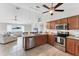 Bright, open kitchen with stainless steel appliances, a breakfast bar, and seamless flow to the living area at 2237 Sadnet Ln, North Port, FL 34286