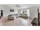 Open-concept living room featuring tile flooring, a large sectional sofa, and bright natural light at 2237 Sadnet Ln, North Port, FL 34286