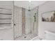 Tiled walk-in shower featuring designer tile accents, sleek glass enclosure, and modern fixtures at 2237 Sadnet Ln, North Port, FL 34286