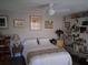 Inviting bedroom featuring a comfortable bed, ceiling fan, and unique decor at 2411 Quail Ct, Bradenton, FL 34209