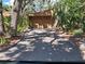 Long driveway leading to a two-car garage, surrounded by lush greenery at 2411 Quail Ct, Bradenton, FL 34209
