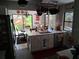 Eat-in kitchen featuring white cabinets and a stainless steel refrigerator at 2411 Quail Ct, Bradenton, FL 34209