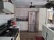 Modern kitchen with stainless steel appliances, white cabinets, and a sleek design at 2411 Quail Ct, Bradenton, FL 34209