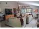 Bright living room with vaulted ceilings, tile floors, and a large window overlooking the yard at 2411 Quail Ct, Bradenton, FL 34209