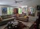 Relaxing living room with comfortable sofas, natural light, and views into the dining area at 2411 Quail Ct, Bradenton, FL 34209
