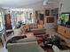 Open-concept living room with tile flooring and neutral decor, filled with light from many windows at 2411 Quail Ct, Bradenton, FL 34209